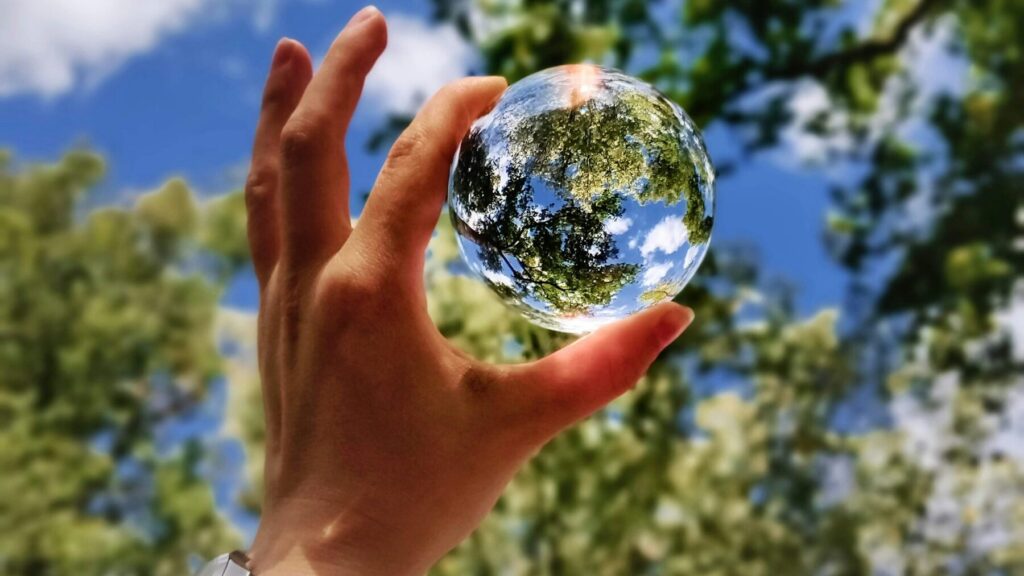 unknown person holding clear glass ball
